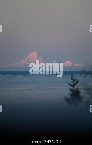 Il vulcano Mt Redoubt torreggia sopra Cook Inlet, vicino ad Anchorage in Alaska, con la penisola di Kenai in primo piano; Alaska, Stati Uniti d'America Foto Stock