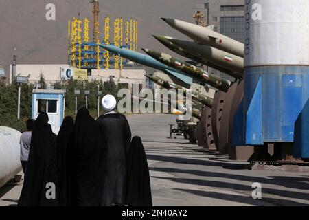 Iranian cleric Mohammad Kalbasi and his family visit an exhibition on the 1980-88 Iran-Iraq war, at a park, northern Tehran, Iran, Thursday, Sept. 25, 2014. Iran begun a week of celebration starting Monday called 'Sacred Defense Week' to mark the 34th anniversary of the outset of its war with Iraq which imposed by the Iraqi dictator Saddam Hussein that left about a million casualties on both sides. (AP Photo/Vahid Salemi)