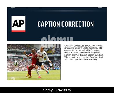 CAPTION CORRECTS LOCATION - West Bromwich Albion’s Saido Berahino, left, competes for the ball with Tottenham Hotspur’s Vlad Chiriches during their English Premier League soccer match at White Hart Lane, London, Sunday, Sept. 21, 2014. (AP Photo/Tim Ireland)