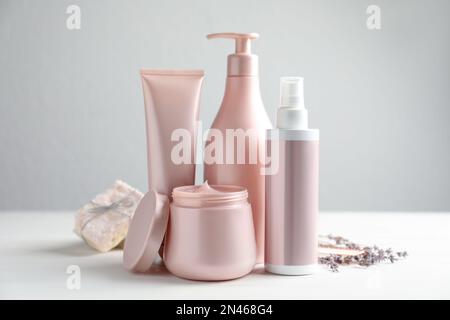 Set di prodotti cosmetici per la cura dei capelli su tavolo bianco Foto Stock