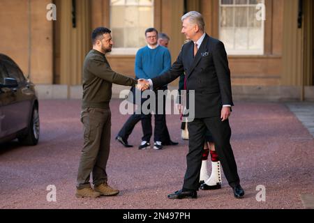 Il presidente ucraino Volodymyr Zelensky viene accolto da Sir Clive Alderton, segretario privato principale di Re Carlo III, mentre arriva per un'udienza con il Re a Buckingham Palace, Londra, durante la sua prima visita nel Regno Unito dopo l'invasione russa dell'Ucraina. Data immagine: Mercoledì 8 febbraio 2023. Foto Stock