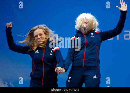 Great Britain's Kelly Gallagher, right, and her guide Charlotte Evans, celebrate their gold medal in the women's alpine skiing, Super-G, visually Impaired event during a medal ceremony at the 2014 Winter Paralympic, Monday, March 10, 2014, in Krasnaya Polyana, Russia. (AP Photo/Dmitry Lovetsky)
