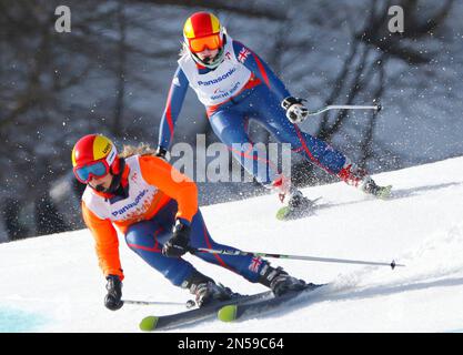 Great Britain's Kelly Gallagher, right, and her guide Charlotte Evans race to win the alpine skiing, ladies Super-G, visually Impaired event at the 2014 Winter Paralympics, Monday, March 10, 2014, in Krasnaya Polyana, Russia. (AP Photo/Dmitry Lovetsky)