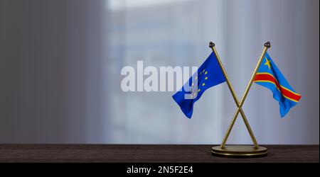 Bandiere della Repubblica democratica del Congo e dell'Europa sul tavolo. Negoziati tra la Repubblica democratica del Congo e l'UE. su sfondo poco sfocato. 3D lavoro AN Foto Stock