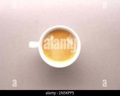 Tazza da caffè bianca con un delizioso espresso biologico dall'odore, vista dall'alto, cibo gustoso, bevande giornaliere Foto Stock