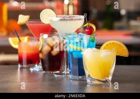 Diversi cocktail deliziosi sul tavolo grigio del bar Foto Stock