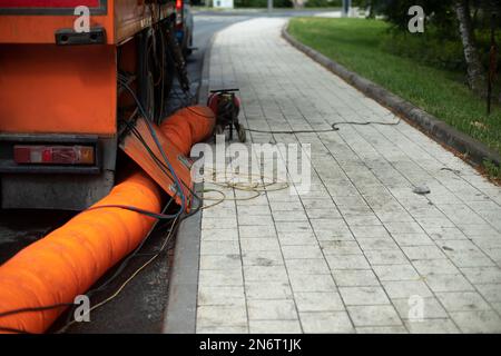 Riparazione fognature. Tubo arancione. Dettagli delle opere in città. Riparazione delle infrastrutture. Foto Stock