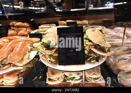 Le sale da pranzo Harrods servono delizie culinarie da tutto il mondo preparate ogni giorno al momento. I piatti che vedete nel fresco mercato Hall sono tutti realizzati in-house dal team di 150 chef. Sotto la guida del capo chef esecutivo Andy Cook e del capo chef senior Andy Ward (le cui carriere hanno incluso stints con Gordon Ramsey e Marcus Waering, rispettivamente), le cucine in loco offrono tutto, dai migliori panini con salsiccia al manzo Wellington, il tutto realizzato con ingredienti delle sale da cucina. Foto Stock