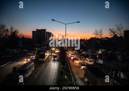 Traffico nel centro della città e il relitto degli edifici distrutti visti durante il tramonto. Lunedì mattina, una forte magnitudine 7,7, centrata nel distretto di Pazarcik, jolted Kahramanmaras e fortemente scosso diverse province, tra cui Gaziantep, Sanliurfa, Diyarbakir, Adana, Adiyaman, Malatya, Osmaniye, Hatay e Kilis. Più tardi, alle 13,24 (1024GMT), un terremoto di magnitudo 7,6 centrato nel distretto di Kahramanmaras' Elbistan colpì la regione. Turkiye ha dichiarato 7 giorni di lutto nazionale dopo terremoti mortali nelle province meridionali. (Foto di Onur Dogman/SOPA Images/Sipa USA) Foto Stock