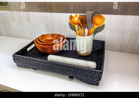 Bancone da cucina con cesto di vimini e cucchiai Foto Stock