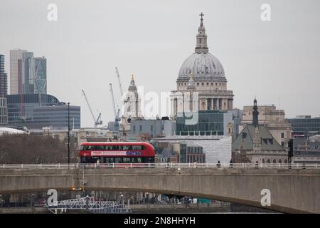 L'autobus rosso di Londra passa davanti alla cattedrale di St Pauls sul London Bridge Foto Stock