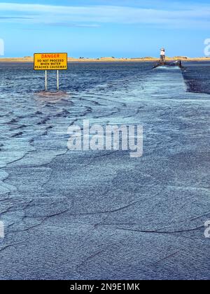 La strada sopraelevata per Lindisfarne sull'Isola Santa al largo della costa del Northumberland nell'Inghilterra nord-orientale. Passabile solo con bassa marea. Foto Stock