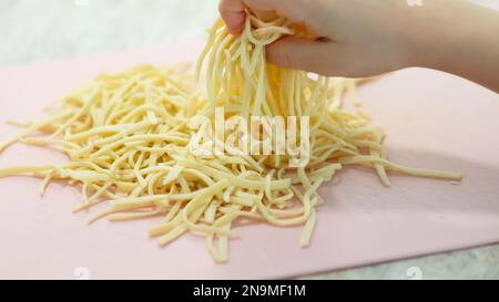 Preparare pasta fatta in casa noodles linguini. Vista frontale. Foto Stock