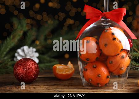 Composizione natalizia con palle di melanzana di mandarino in wineglass su tavola di legno. Spazio per il testo Foto Stock