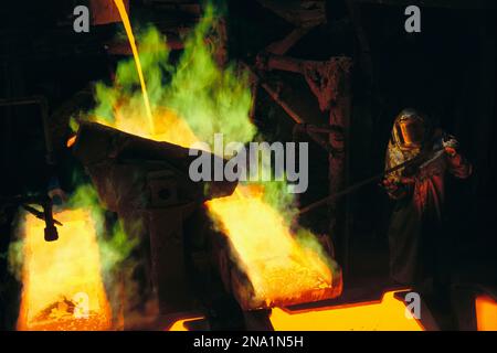 Man in equipaggiamento protettivo si occupa di fonderia presso la Magma Metals Company, vicino a San Manuel, Arizona, Stati Uniti; Arizona, Stati Uniti d'America Foto Stock