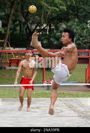 Myanmar workers play a traditional game of chin lone in a park in Kuala ...