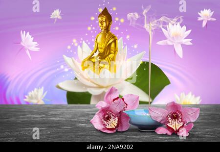 Composizione con incenso bruciante sul tavolo e figura di Buddha sullo sfondo Foto Stock