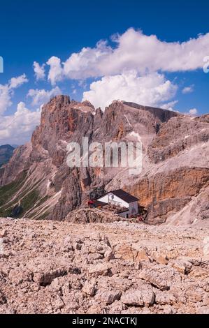 Building and mountain peaks at San Martino di Castrozza in The Dolomites; Trentino-Alto Adige, Trentino, Italy Stock Photo