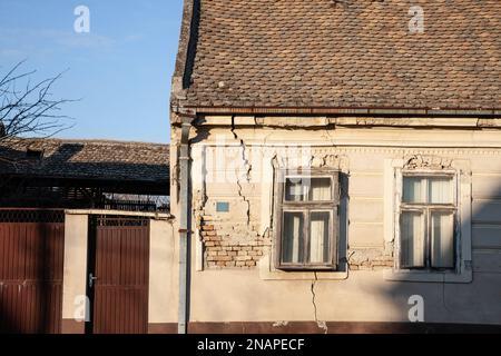 Immagine di una facciata spaccata con un uso spaccato in diagonale, minacciando la struttura dell'edificio in una fattoria abbandonata in Vojvodina, in Serbia, con Foto Stock