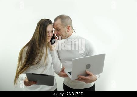 uomo e donna lavoro capo e subordinati in mani portatile tablet telefono problema di risoluzione parlare al telefono su sfondo bianco insegnante e studente padre e figlia progetto congiunto Foto Stock