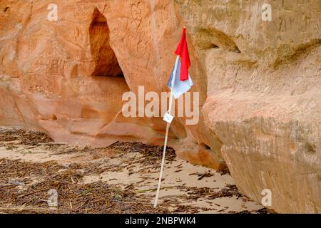 Bella in tutte le condizioni atmosferiche, colorate scogliere di arenaria con bandiere da pesca. Bella costa del Mar Baltico con grotte. Ciottoli Veczemju, scogliera Veczemju Foto Stock