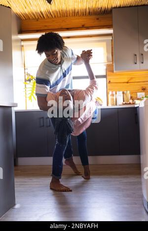 Coppia afro-americana felice che passa il tempo nella balli della cabina del ceppo. Cabina di legno, natura e concetto di stile di vita. Foto Stock