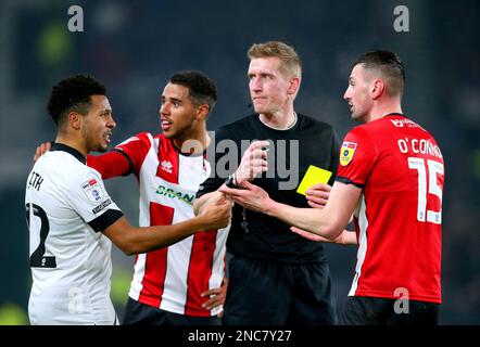 Korey Smith (a sinistra) della contea di Derby e Padie o'Connor di Lincoln City parlano con l'arbitro Scott Oldham durante la partita della Sky Bet League One al Pride Park Stadium, Derby. Data immagine: Martedì 14 febbraio 2023. Foto Stock