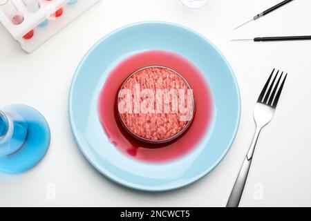 Carne coltivata macinata servita su un tavolo da laboratorio bianco, piatto Foto Stock