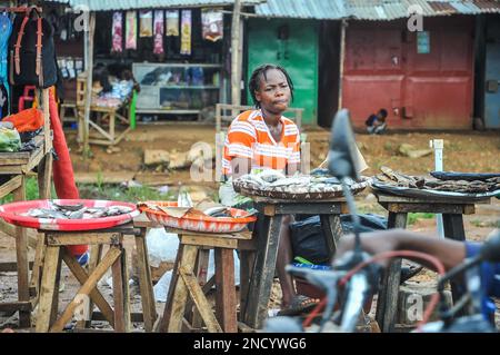 Comprare e vendere su una Monrovia trafficata - Gbarnga Highway. Il mercato è un luogo molto affollato, e i venditori occupano parte della strada che causa ingorghi pesanti. Liberia. Foto Stock