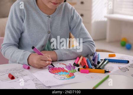 Bambino disegno di colorazione al tavolo in camera, primo piano Foto Stock