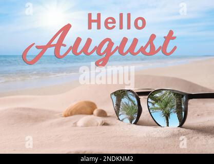 Ciao agosto. Occhiali da sole sulla spiaggia di sabbia vicino al mare Foto Stock