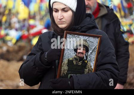 KHARKIV, UCRAINA - 16 FEBBRAIO 2023 - Una donna detiene il ritratto di attivista Euromaidan, vice comandante dell'ospedale Hennadii Kovshyk durante la funera Foto Stock