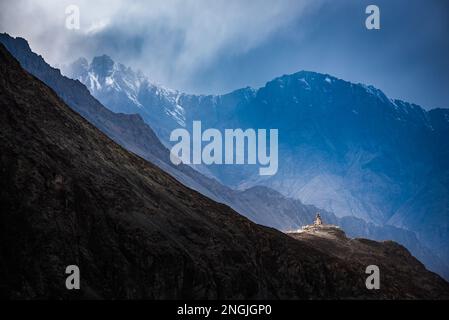 La statua del Buddha Maitreya con le montagne Himalaya sullo sfondo dal monastero di Diskit, la valle di Nubra, Leh Ladakh Foto Stock