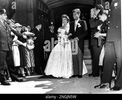 Senator John F. Kennedy, D-Mass., is shown with his bride, the former Jacqueline Bouvier, leaving a Newport, RI church after their wedding on September 12, 1953. (AP Photo)