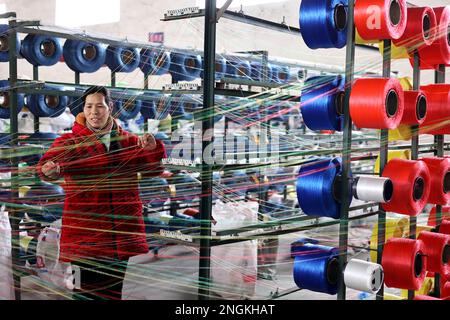 BINZHOU, CINA - 18 FEBBRAIO 2023 - Un lavoratore produce i prodotti della rete della corda ad un'officina di un'impresa della rete della corda nella città di Jianglou, contea di Huimin, Binzh Foto Stock