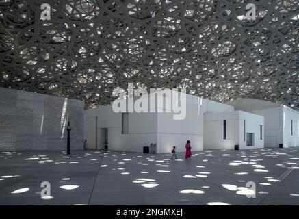 Visitatori sotto la pioggia leggera del Louvre Abu Dhabi, l'architetto Jean Nouvel, l'isola di Saadiyat, Abu Dhabi, Emirati Arabi Uniti Foto Stock