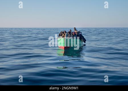 Barca con 31 migranti visti minuti prima di essere portati in sicurezza dalla ONG spagnola Salvamento Maritimo squadra di salvataggio umanitario a SAR Malta Waters il 15 febbraio. Mercoledì 15 febbraio, alle ore 15:00 circa, la nave di salvataggio Aita Mari della ONG basca SMH ha avvistato una barca di legno di meno di 5 metri che galleggiava nella zona di Malta della SAR, Intorno alle 15:30 ore il salvataggio ha cominciato 33 miglia al largo della costa tunisina per portare 31 migranti sub-sahariani in sicurezza. Foto Stock