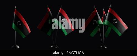 Piccole bandiere nazionali della Libia su sfondo nero. Foto Stock