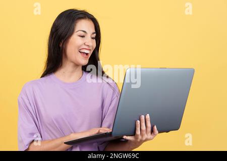 Donna caucasica sorridente mentre usa un notebook Foto Stock