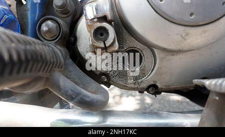 Foro trasparente nel monoblocco sporco di olio. funzione di controllo del livello dell'olio motore sulla motocicletta Foto Stock