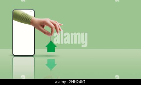 Agente immobiliare mano in uno schermo di smartphone tenendo i vostri nuovi tasti casa, concetto di app immobiliare, spazio di copia Foto Stock