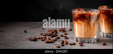 Caffè ghiacciato in un bicchiere con panna versata. Bevanda estiva fredda. Foto Stock