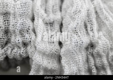 Chiudi colpo di cotone materiale cheesecloth - tessuto lavato e asciugato ma non appiattito / stirato in modo stropicciato curvatura e trama texture. Per l'industria del cotone. Foto Stock