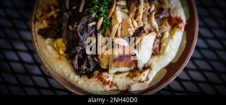 Hummus con shwarma di agnello e pollo sparato mezza porzione Foto Stock