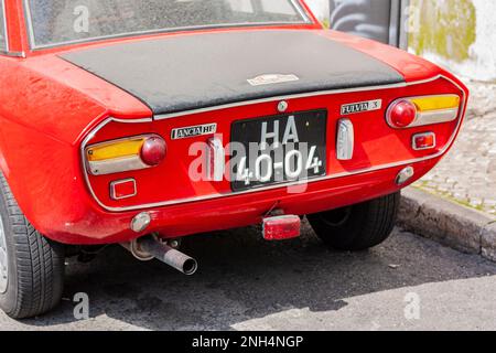 close up of rear of classic vintage Dusty red Lancia Fulvia in a Lisbon Street Portugal Foto Stock