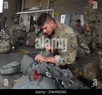 Il Sig. Anthony Husey fotografa i soldati del 143rd° Reggimento della fanteria aerea, 1st° Battaglione, Charlie Company, del Rhode Island mentre preparano i loro attrezzi per un salto serale alla fine della sessione annuale di allenamento il 31 luglio 2022. La loro missione come unità aerea è altamente specializzata, e l'unità treni per essere il migliore nel loro campo. (Foto della Guardia Nazionale del Minnesota di Anthony Housey) Foto Stock