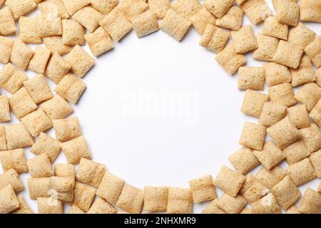 Cornice realizzata con deliziose pannocchie di mais su sfondo bianco, vista dall'alto. Spazio per il testo Foto Stock