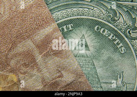 Un hryvnia Ucraina ed un dollaro americano come macro di fondo Foto Stock