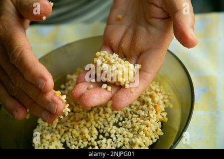 Penellets. Piccoli dolci di varie forme, realizzati con pasta di mandorle e patate, ricoperti di mandorle o pinoli. Foto Stock