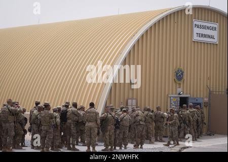 STATI UNITI Esercito Task Force Griz soldati del 1st Combined Arms Battalion, 163rd Cavallry Regiment, arrivano a inprocessare attraverso il 386th Expeditionary Logistics Readiness Squadron terminal passeggeri durante un'emergenza di implementazione rapida esercizio presso Ali al Salem Air base, Kuwait, 10 agosto 2022. L’EDRE ha testato la rapidità con cui i soldati potevano riferire al terminale PAX e la rapidità con cui gli Airmen del 386th ELRS sono stati in grado di elaborare un movimento di massa di personale militare attraverso il terminale e su un aeromobile in un momento. Foto Stock